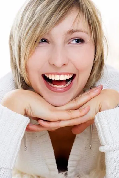 woman smiling big after her first visit to Ronald Fuhrmann DDS