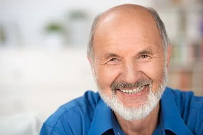 man smiling after his restorative dentistry appointment at Ronald Furhmann DDS