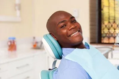man smiling in the dental chair