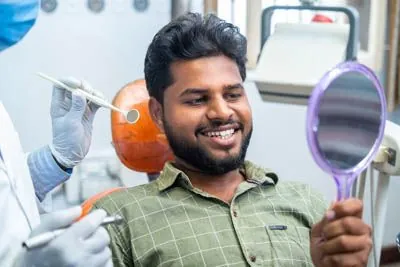man loving his smile after getting dental bridges in Virginia Beach, VA