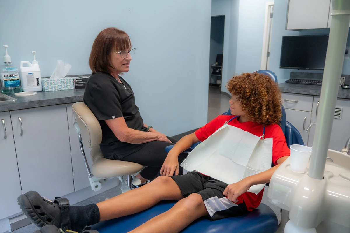 Our friendly dental team speaking with a young man about our preventative dentistry options at Ronald Fuhrmann - Virginia Beach VA.