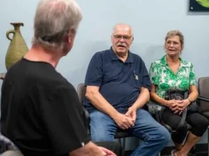 Dr. Ronald Fuhrmann discussing treatment with patients at his office
