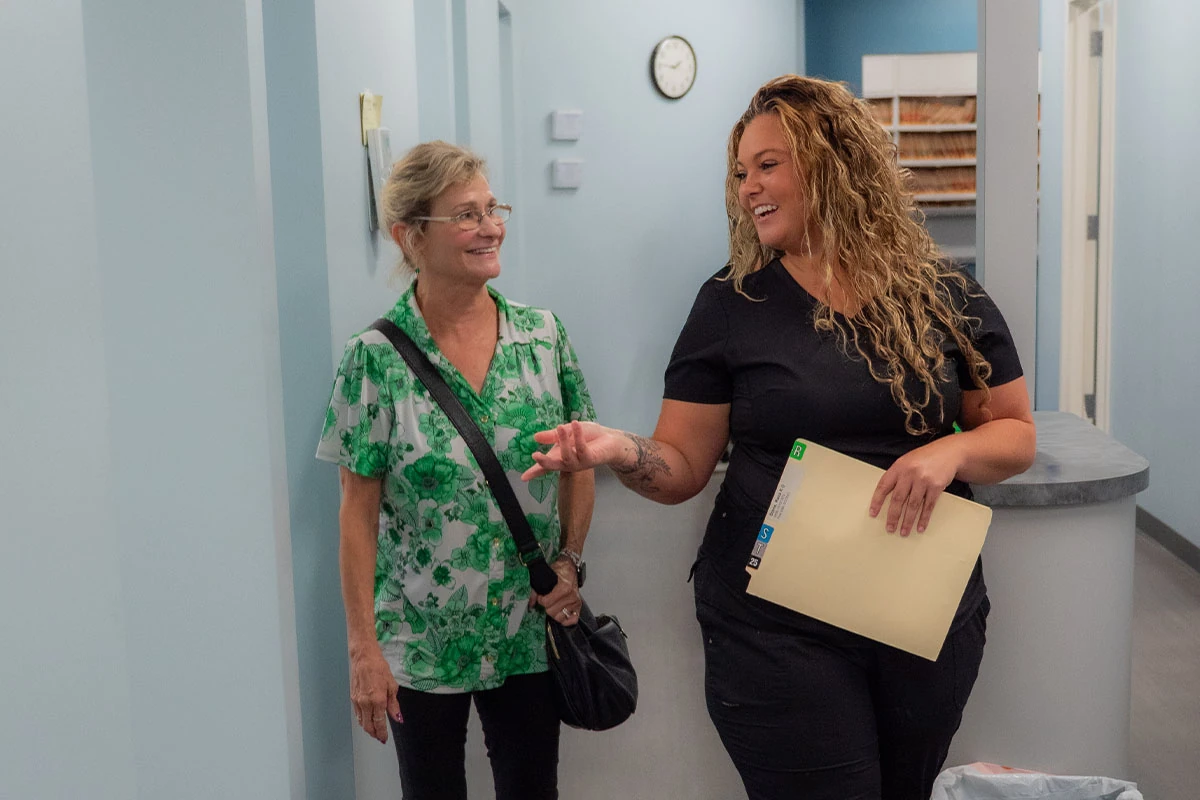 Patient speaking with a team member about stress free dentistry with insurance and financing options at Ronald Fuhrmann - Virginia Beach VA.