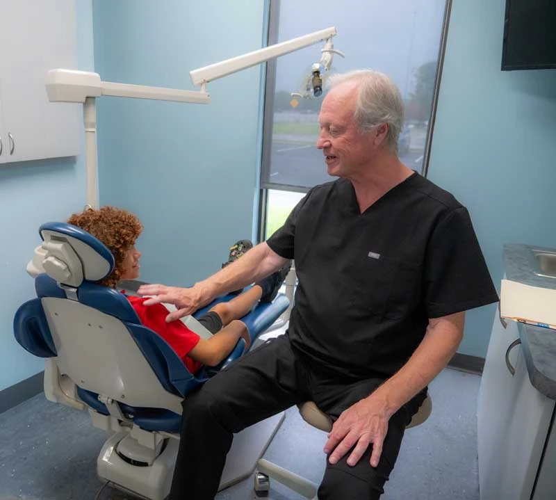 Dentist Dr Ronald Fuhrmann consulting with a young patient about clear aligners at Ronald Fuhrmann - Virginia Beach VA